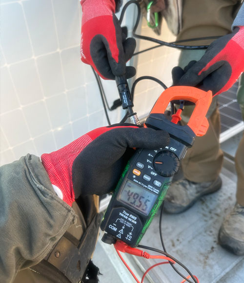 hands holding solar panel meter